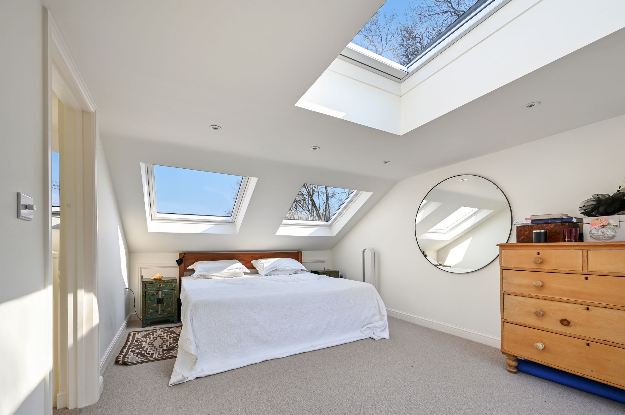 Loft conversion bedroom with skylights